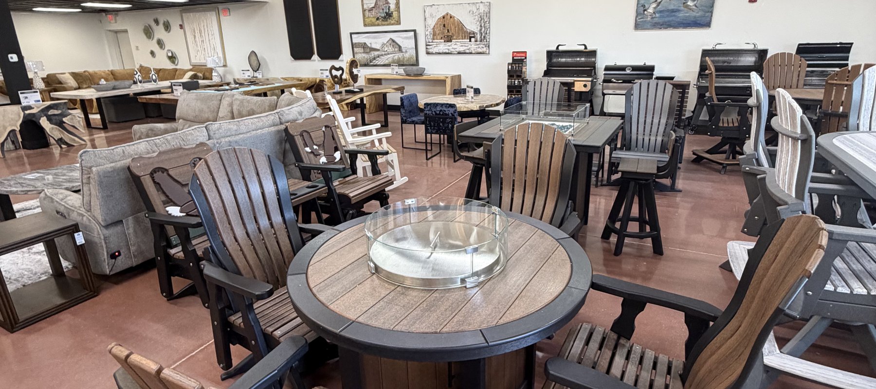 Amish poly outdoor dining and fire-pit tables with Adirondack-back swivel chairs in the outdoor showroom at Lakehouse Furniture Gallery in Osage Beach, Missouri.